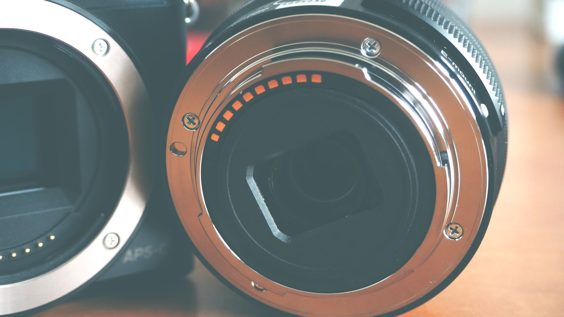 Detailed close-up of a modern camera lens adapter showing metallic design and round shape.