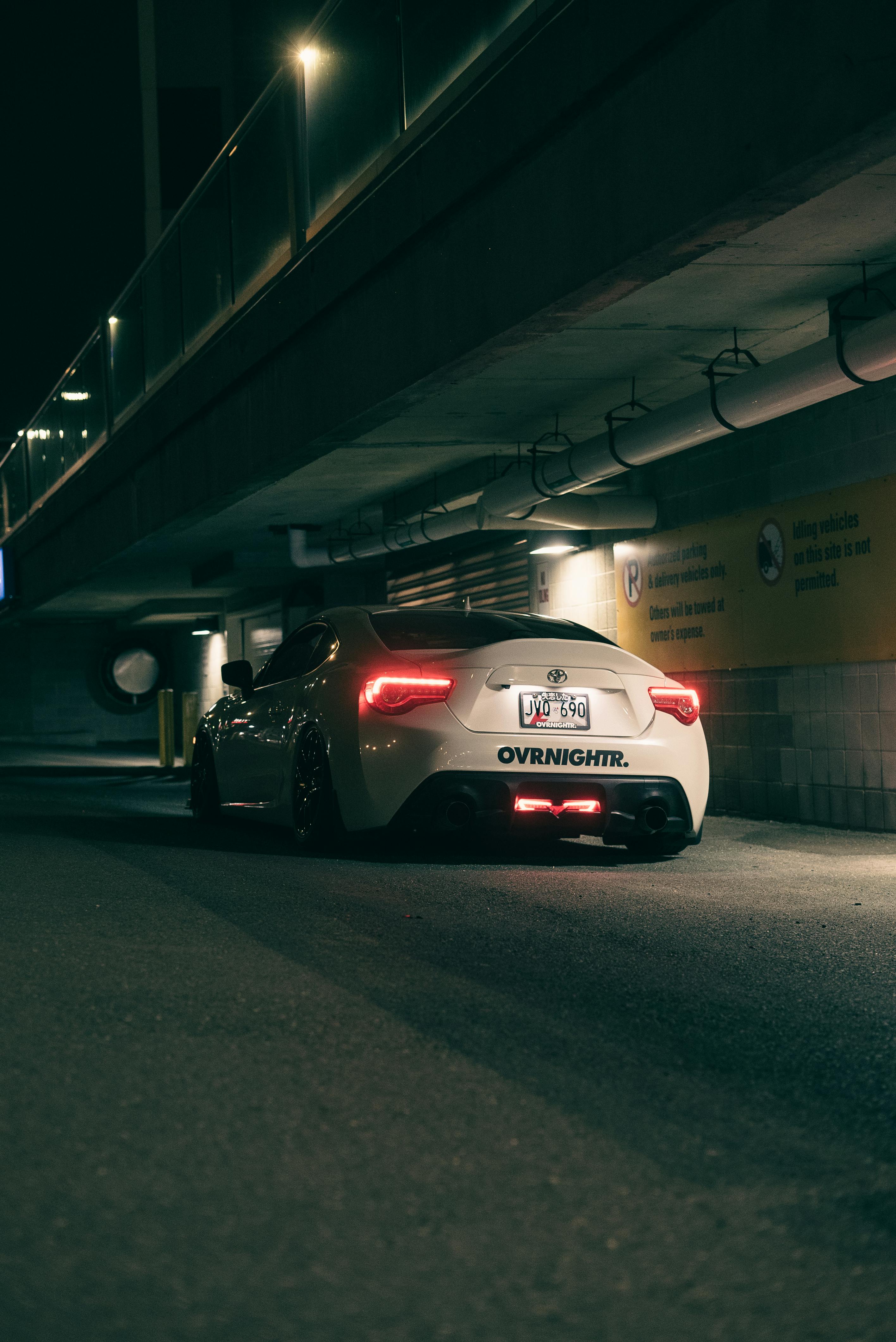 Sports Car Under Bridge at Night