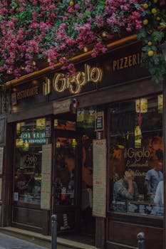 Exterior of an Italian restaurant adorned with vibrant flowers and signage.
