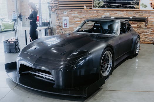 A sleek black sports car on display in a modern showroom setting, capturing elegance and performance.