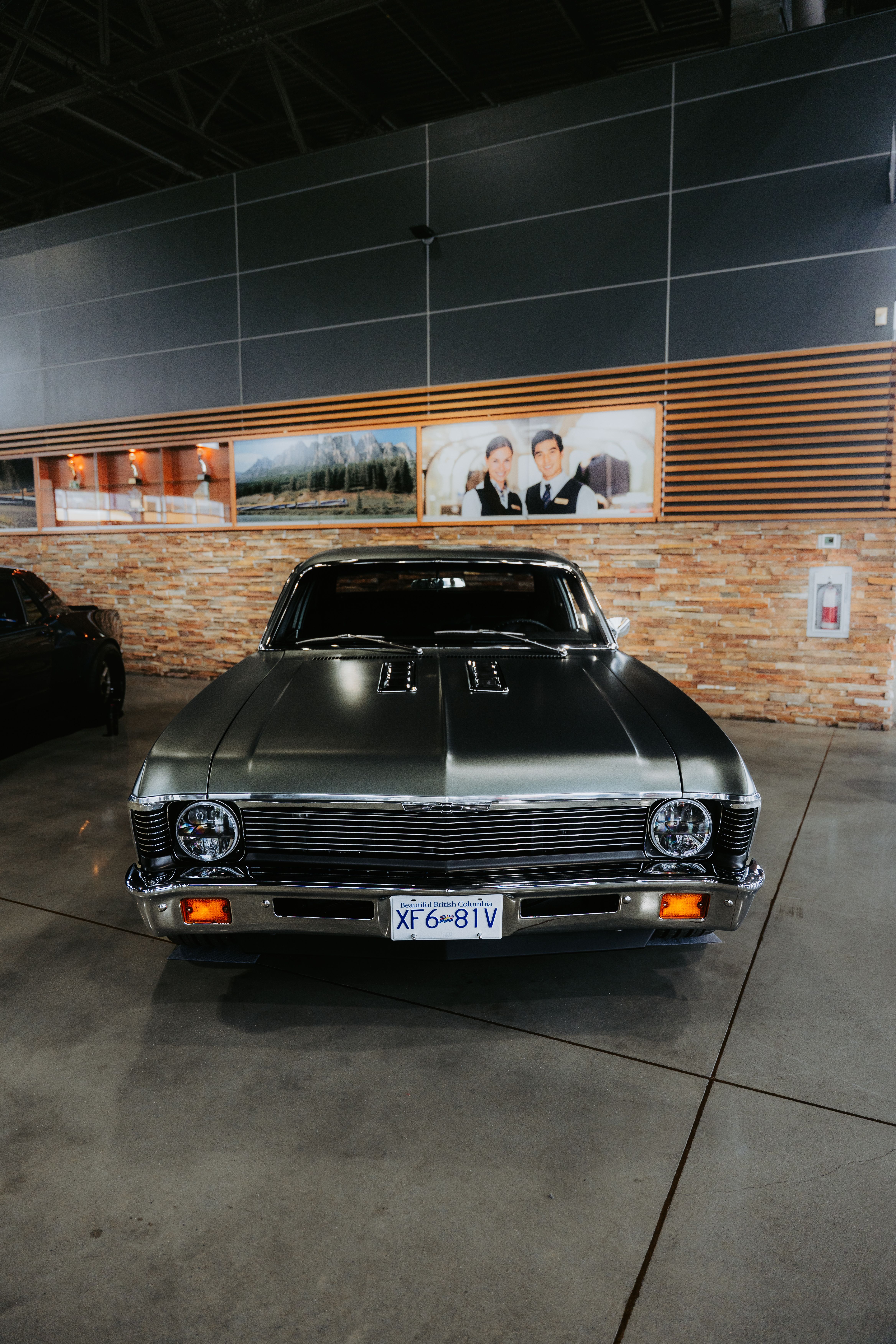 Front view of a classic vintage car displayed in an indoor showroom.