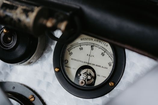 Detailed view of a vintage Weston ammeter gauge, showcasing intricate mechanical design in classic machinery.