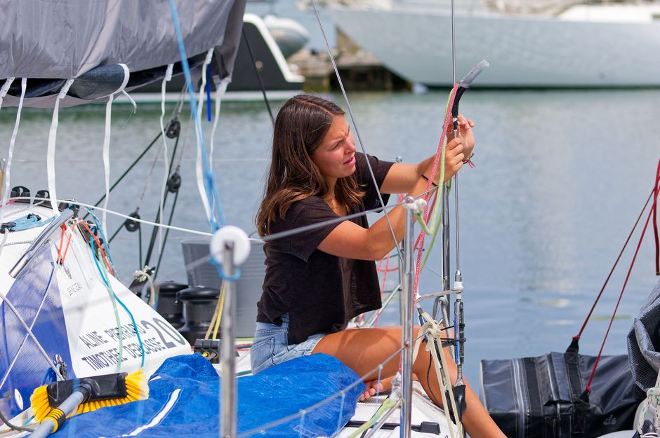 Incredible Maui: Molokini and Turtles Luxury Yacht Snorkel Review 2026 - A young woman adjusts a sail on a docked sailboat, showcasing her sailing skills.