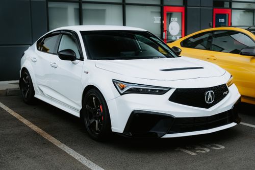 Free Stylish white sports sedan parked in an urban setting, showcasing modern car design. Stock Photo