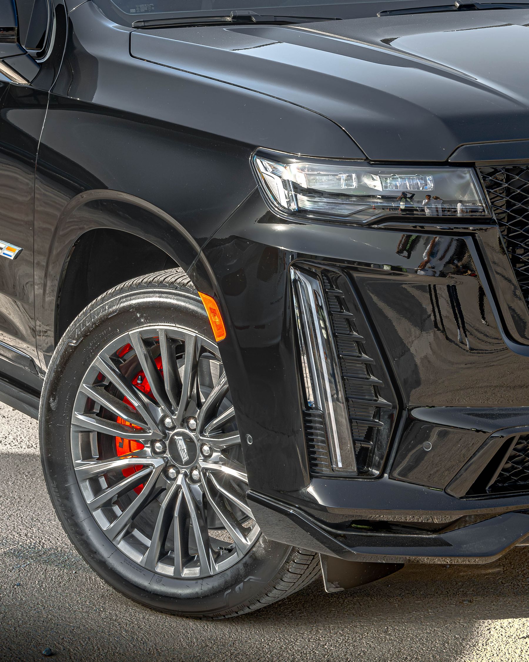 Close view of a luxury SUV front wheel and fender after detailing