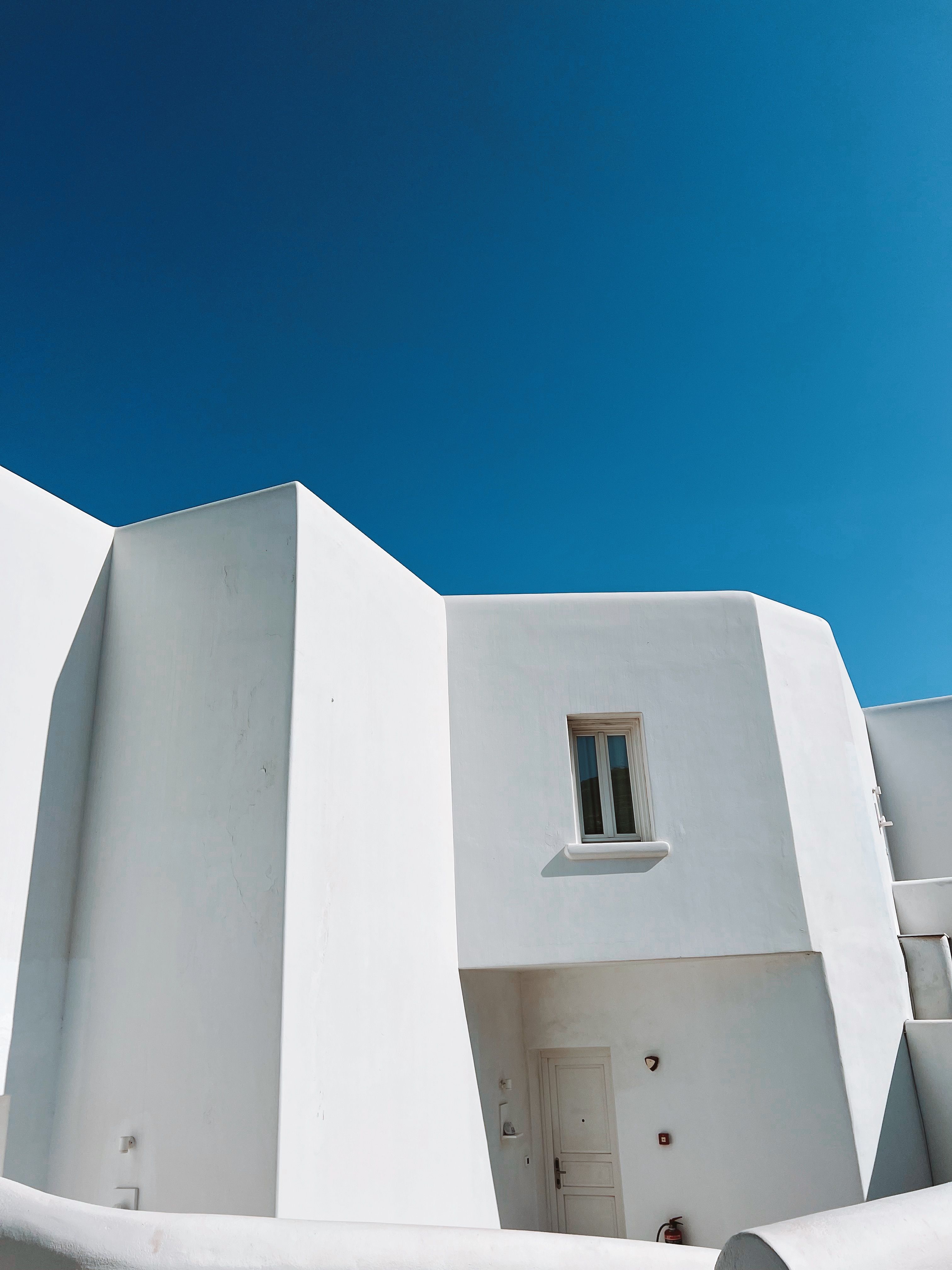 Whitewashed Architecture Against Clear Blue Sky · Free Stock Photo