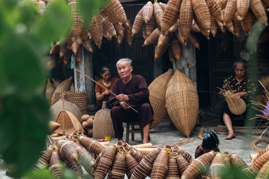Artisans crafting traditional baskets in Hà Giang, Vietnam.