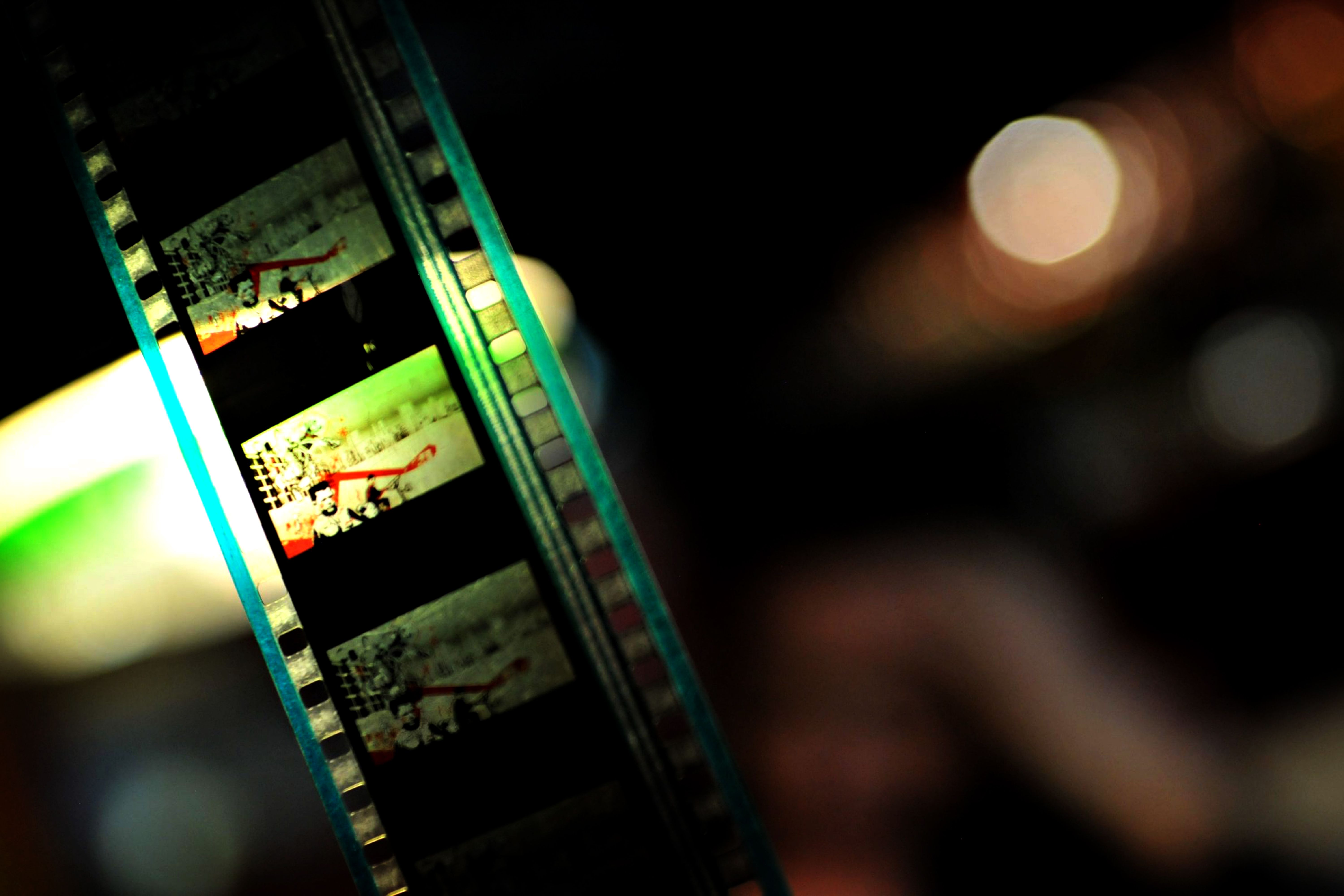 Free Close-up of a vintage film reel showcasing vibrant colors and cinematic art, highlighting the essence of classic filmmaking. Stock Photo