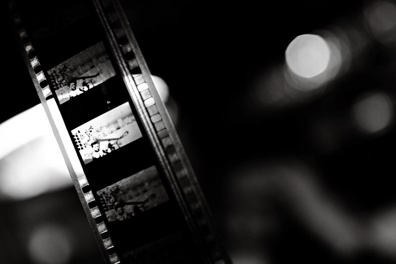 A close-up of a vintage film strip in black and white, capturing the essence of classic cinema.