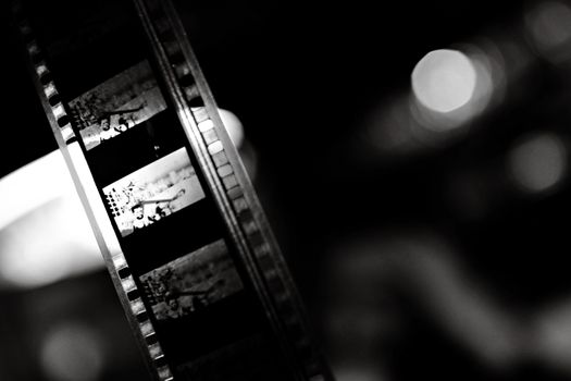 A close-up of a vintage film strip in black and white, capturing the essence of classic cinema.