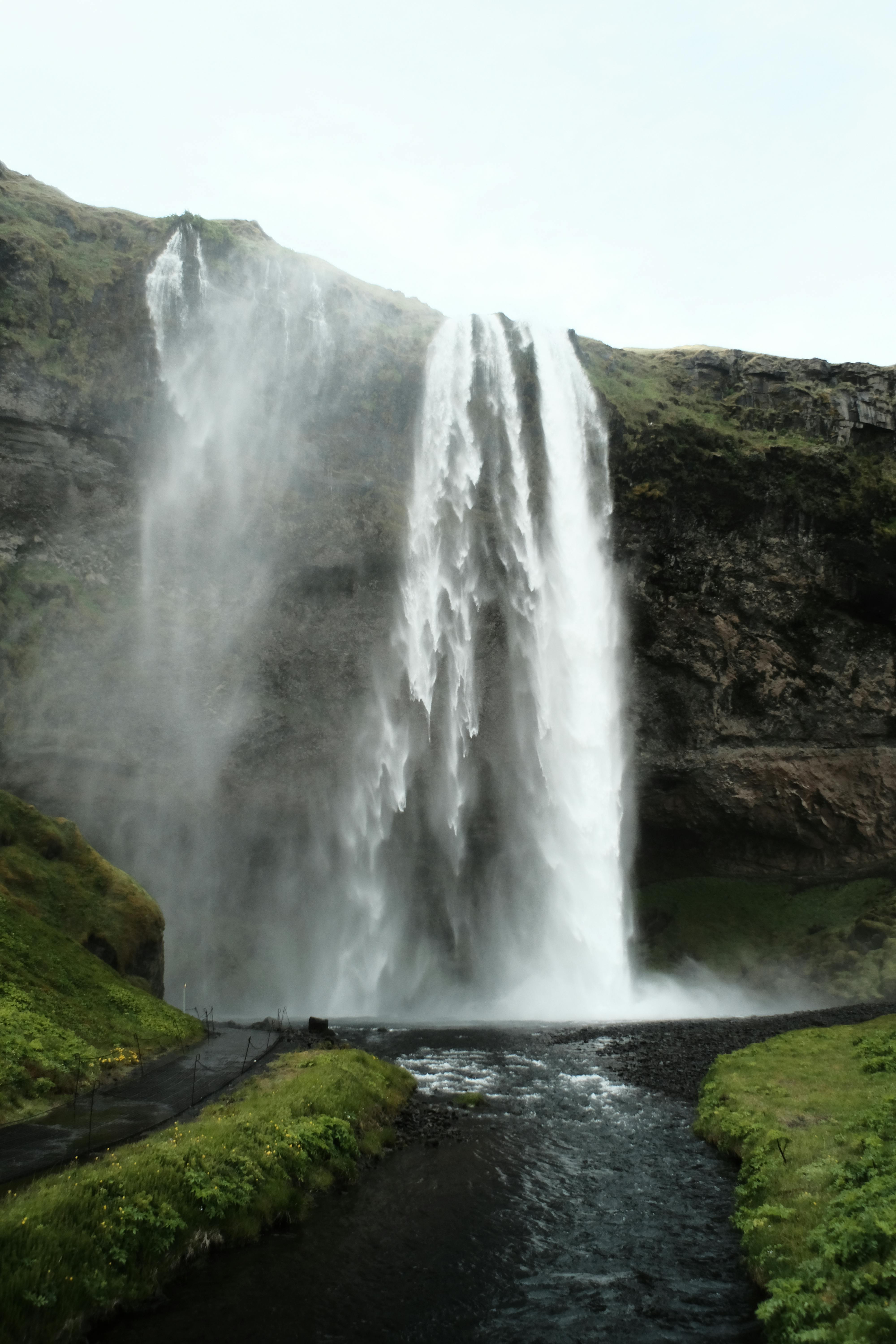 Stunning view of Seljalandsfoss waterfall cascading in Iceland's natural landscape.