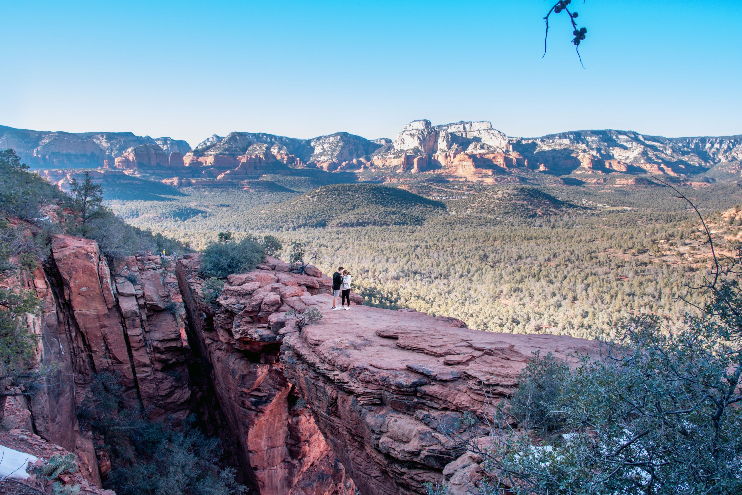 Hikers overlooking Sedona’s vivid red rock formations and high desert landscape