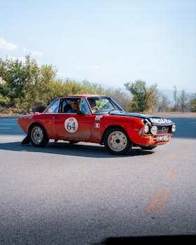 A classic red vintage car participates in a daytime rally event in Ankara, Turkey.