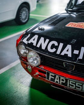 Close-up of a classic Lancia car in a parking garage, showcasing vintage design.