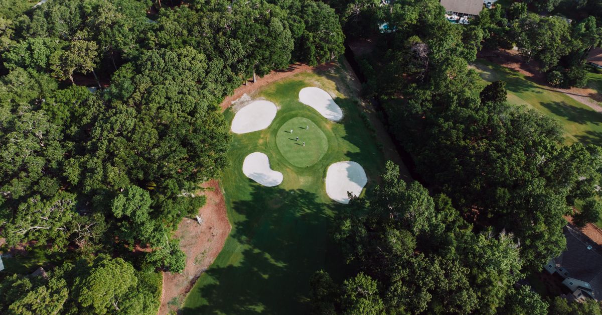 Aerial view of lush golf course surrounded by trees in Hilton Head, South Carolina.