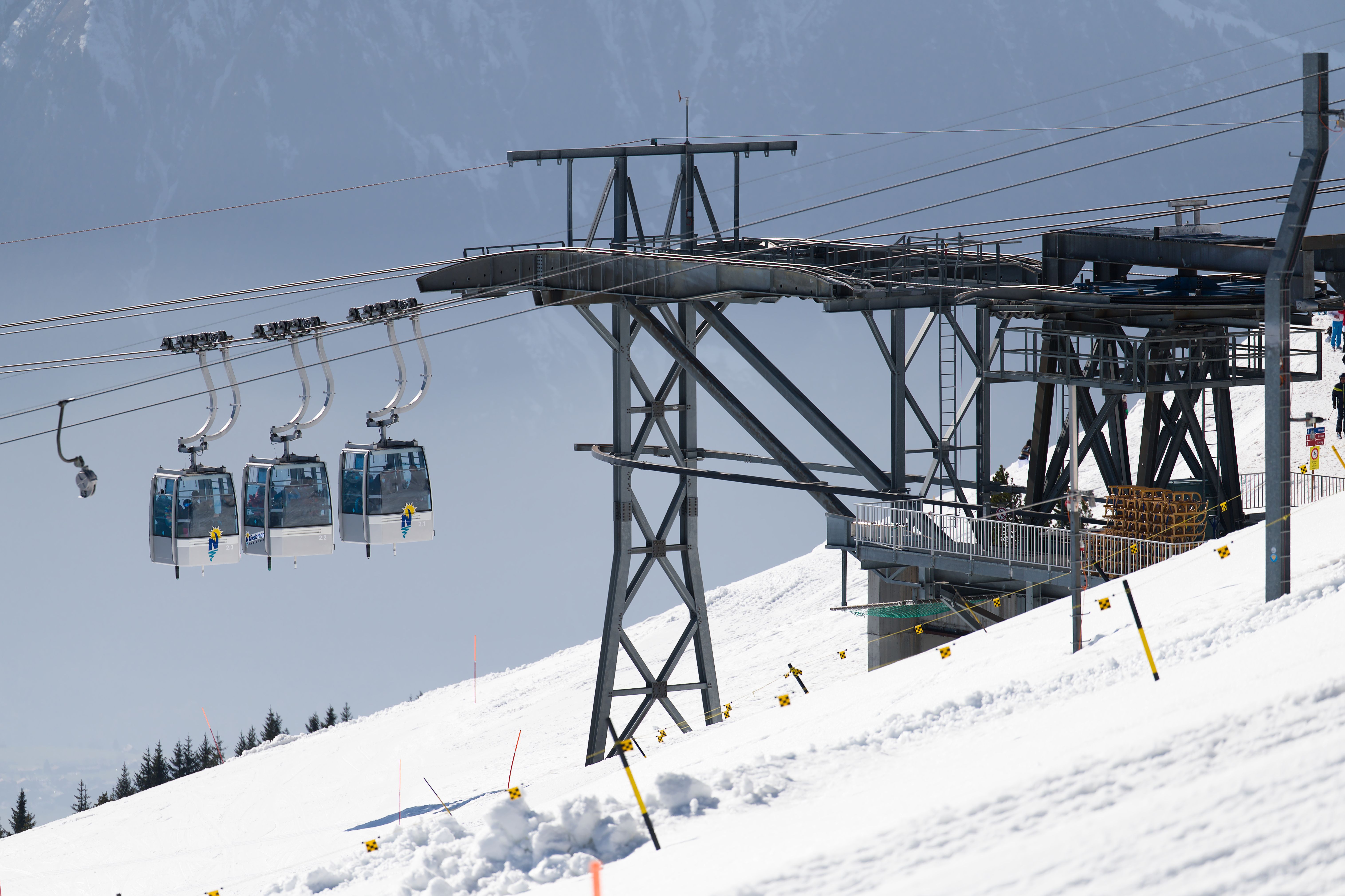 Ski lift gliding over snowy slopes in the Swiss Alps on a clear winter day.