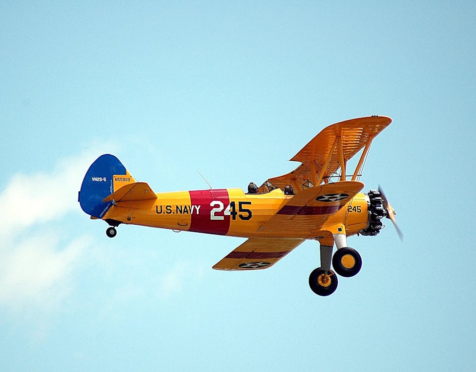 Free Airplane Flying Against Sky Stock Photo