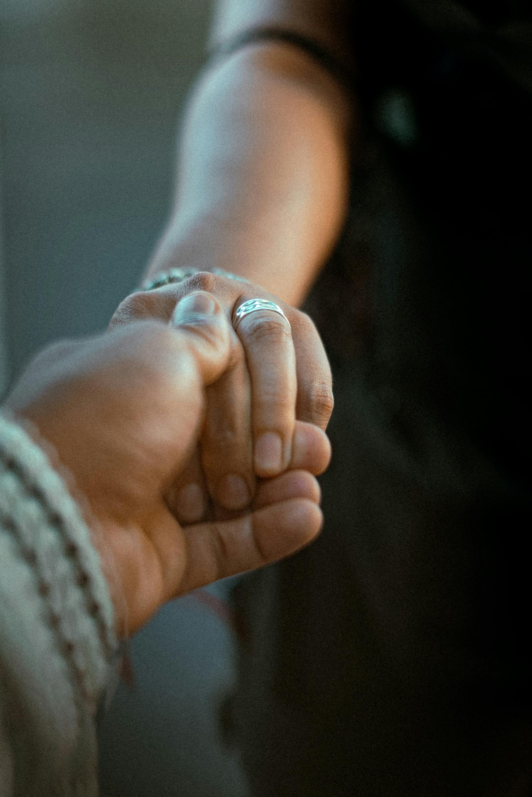 Free A close-up of two people holding hands, symbolizing connection and intimacy. Stock Photo