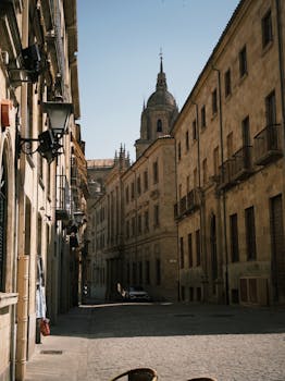 Charming old European street with architectural details and cathedral view.