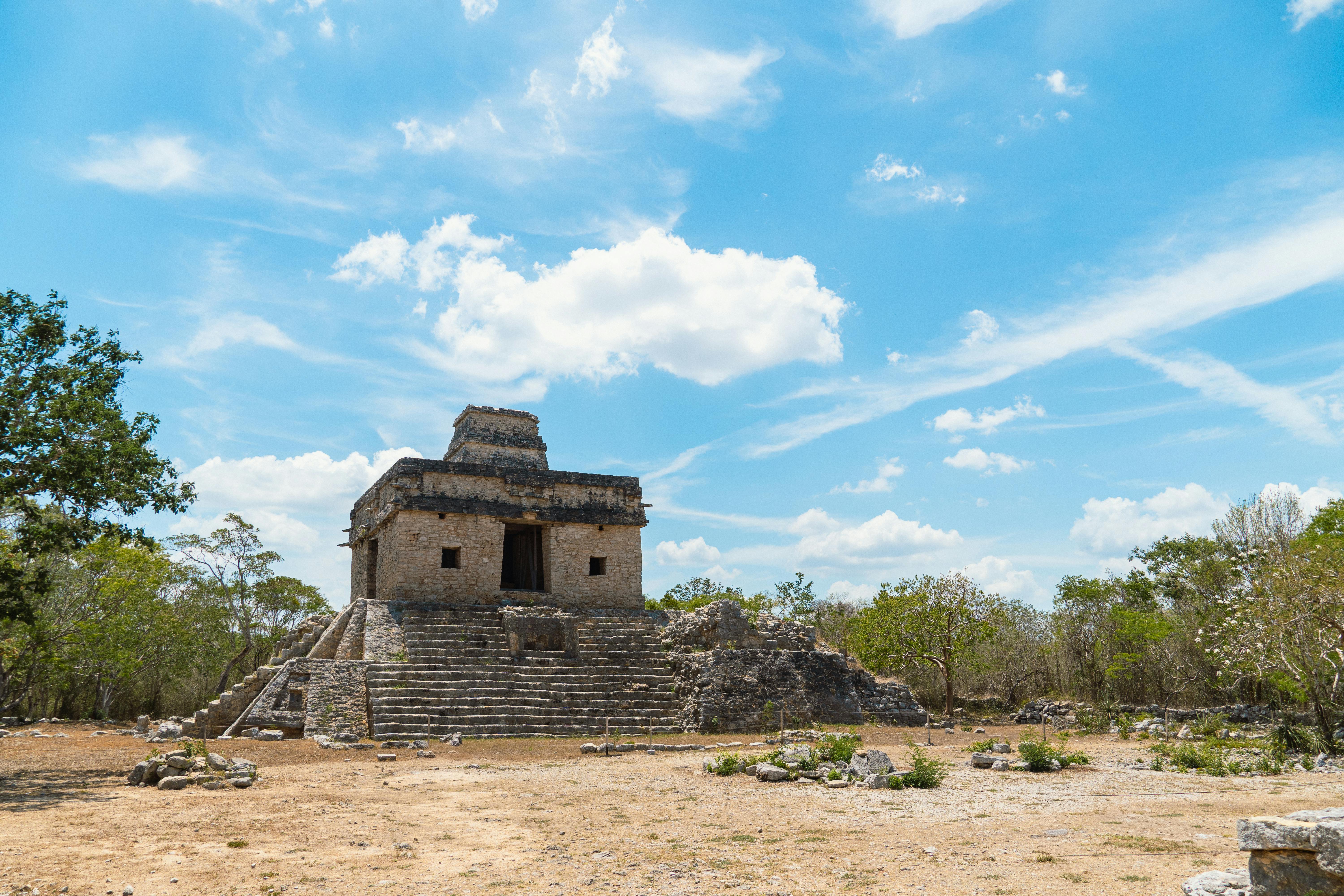 best time to visit riviera maya mayan ruins for client bookings - Explore the historic Mayan temple at Dzibilchaltún, Yucatan, under a vibrant blue sky.