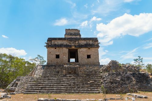 Free Explore the iconic Temple of the Seven Dolls at Dzibilchaltún, highlighting Mayan architecture against a vivid blue sky. Stock Photo