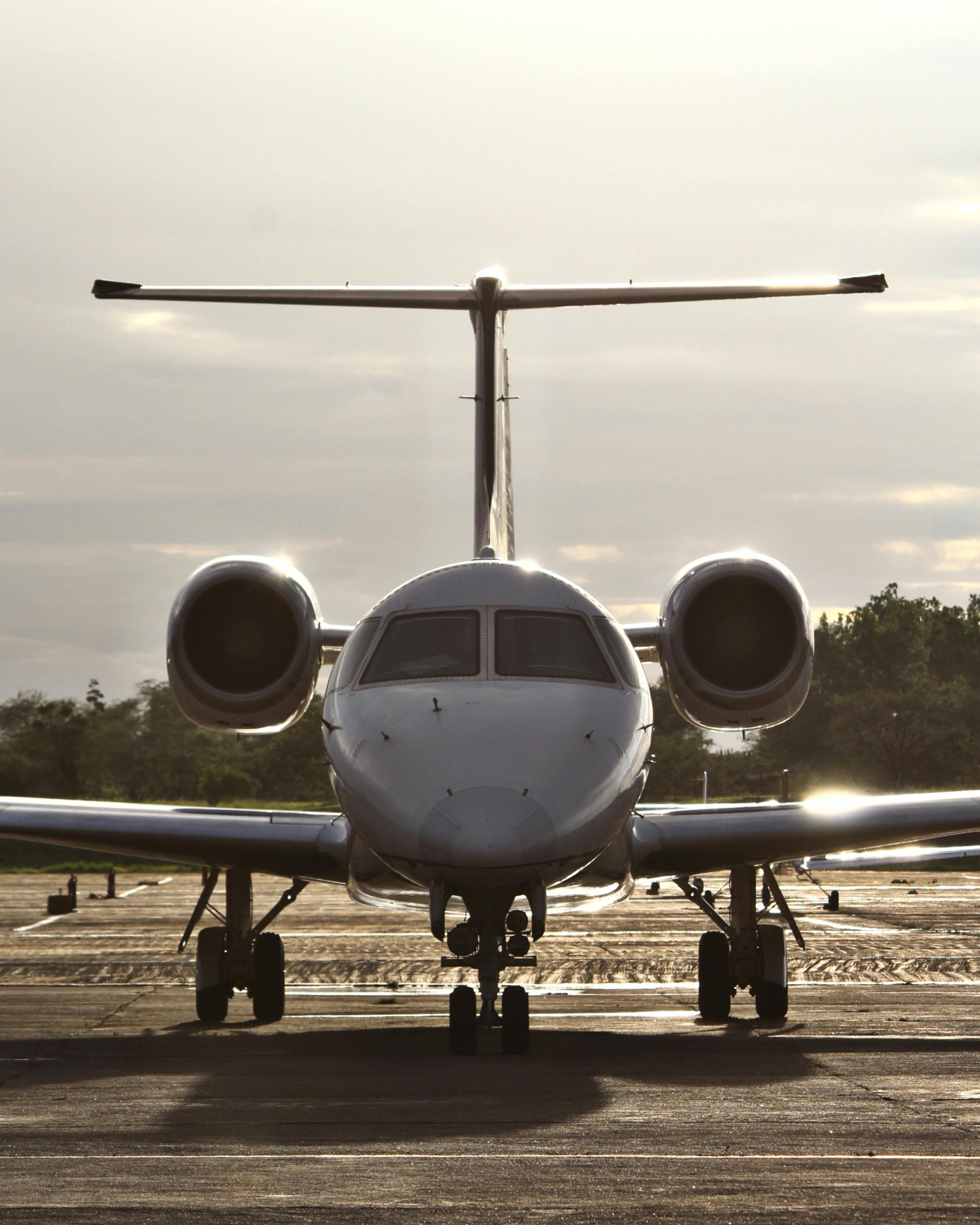 Luxury private jet on runway at sunset golden hour