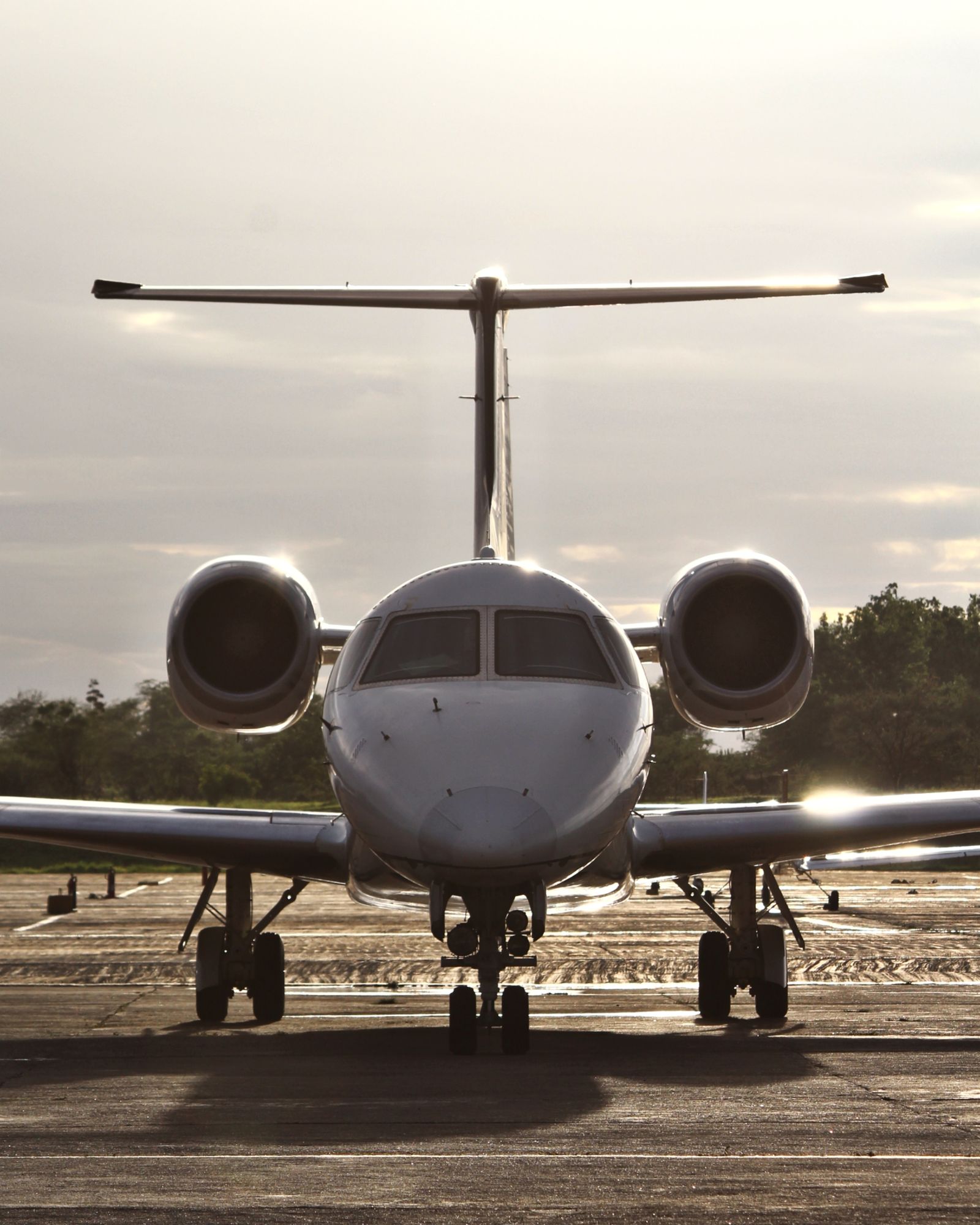 A private jet on the runway at sunset