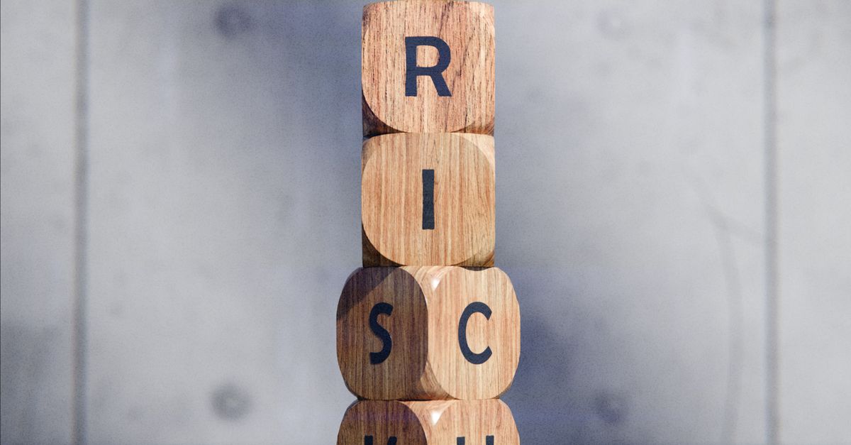 Photo by Pușcaș Adryan Stacked wooden blocks spelling 'RISK' concept, symbolizing caution and strategy.