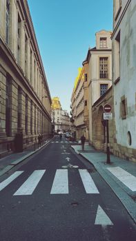 Charming Paris street view with historic architecture under a clear sky.