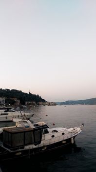 A peaceful evening scene of boats docked along the Bosphorus Strait in Istanbul, Türkiye.