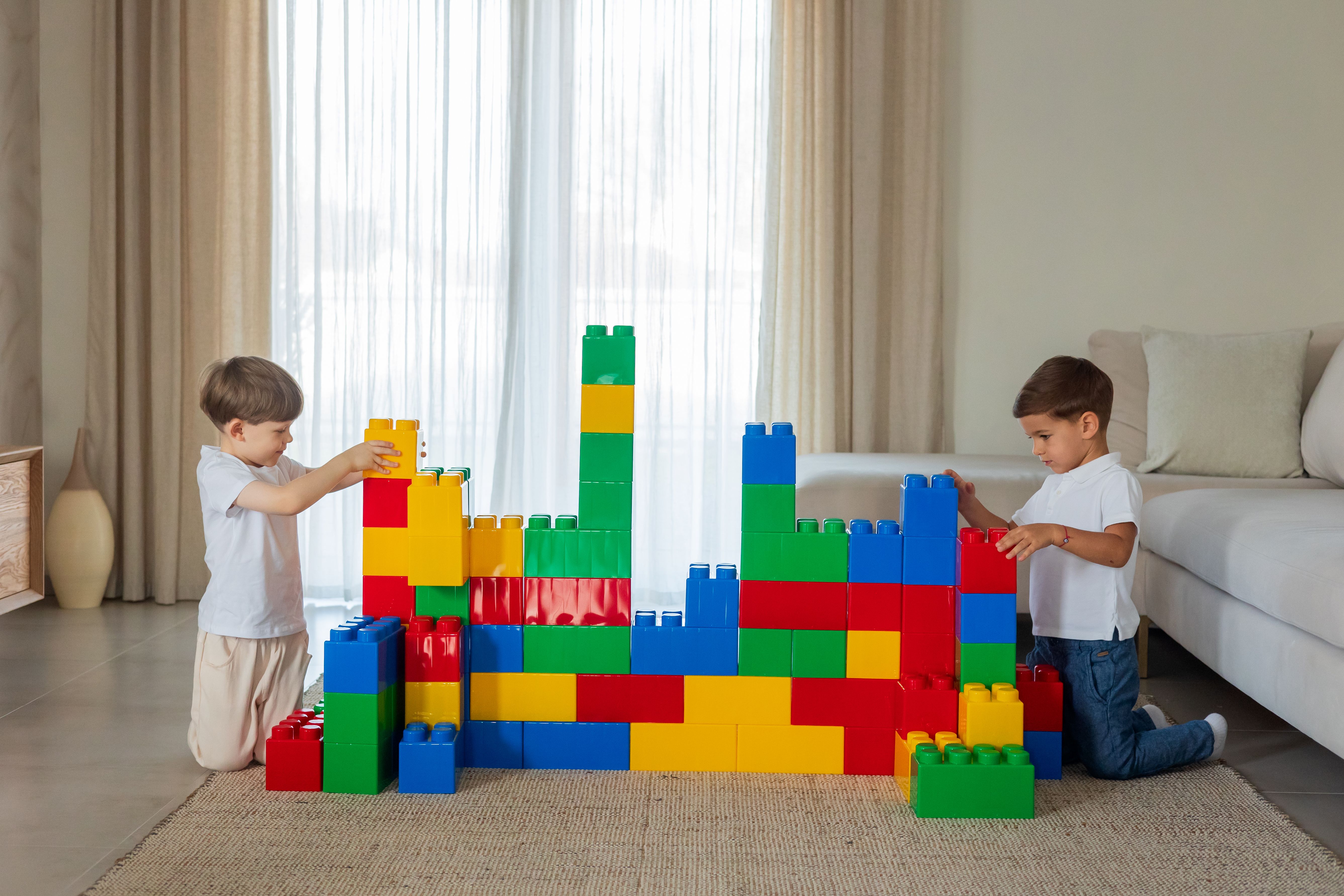 Children Playing with Colorful Building Blocks Indoors · Free Stock Photo
