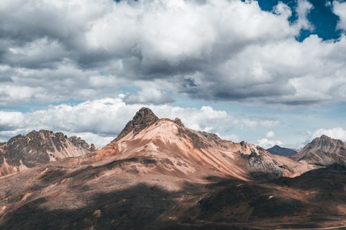 Free Stunning mountain landscape in Lima, Peru, showcasing rocky peaks beneath a dramatic sky. Stock Photo