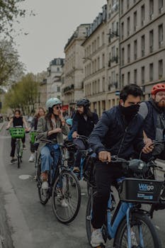 Group of cyclists navigating the streets of Paris on a casual day ride.
