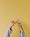 Elegant Hands Against Vibrant Yellow Background