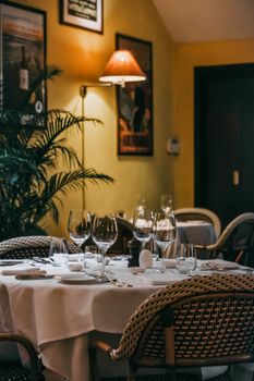 Cozy restaurant interior with elegantly set table under warm lighting, perfect for dining ambiance.
