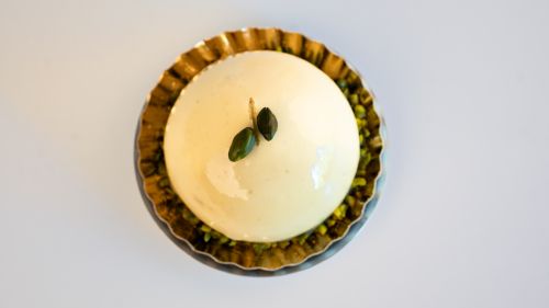 Free A top view of a creamy gourmet dessert garnished with pistachios, perfect for elegant dining settings. Stock Photo