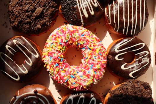 Bright and delicious donuts with sprinkles and chocolate, perfect for bakery promotions and dessert lovers.