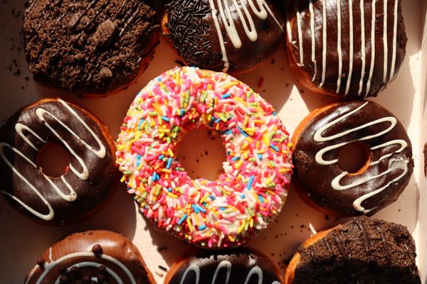 Tray of glazed and sprinkled doughnuts, photo by Aditya Aiyar on Pexels