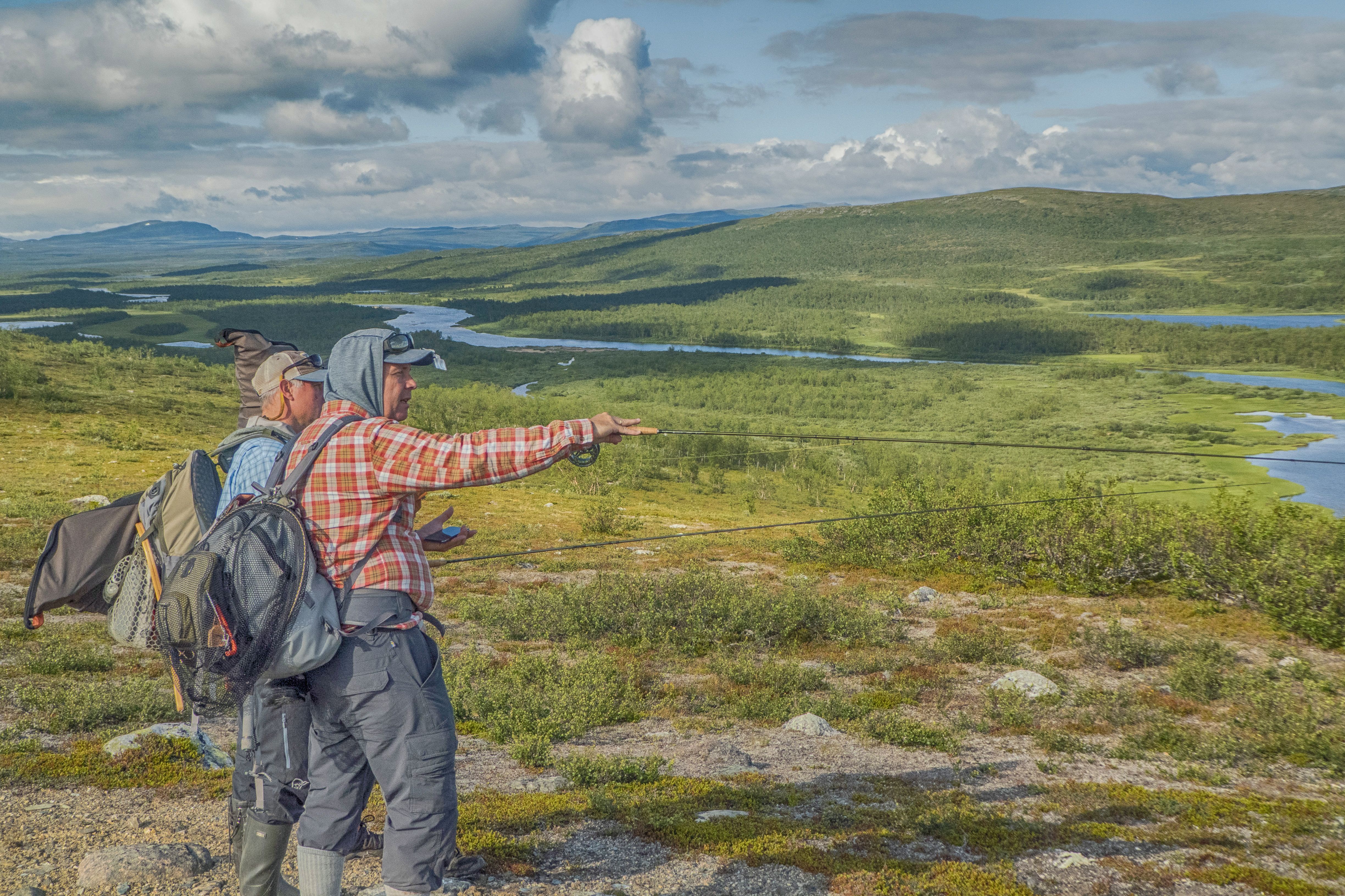 Anglers Exploring Scenic Landscape in Finnmark