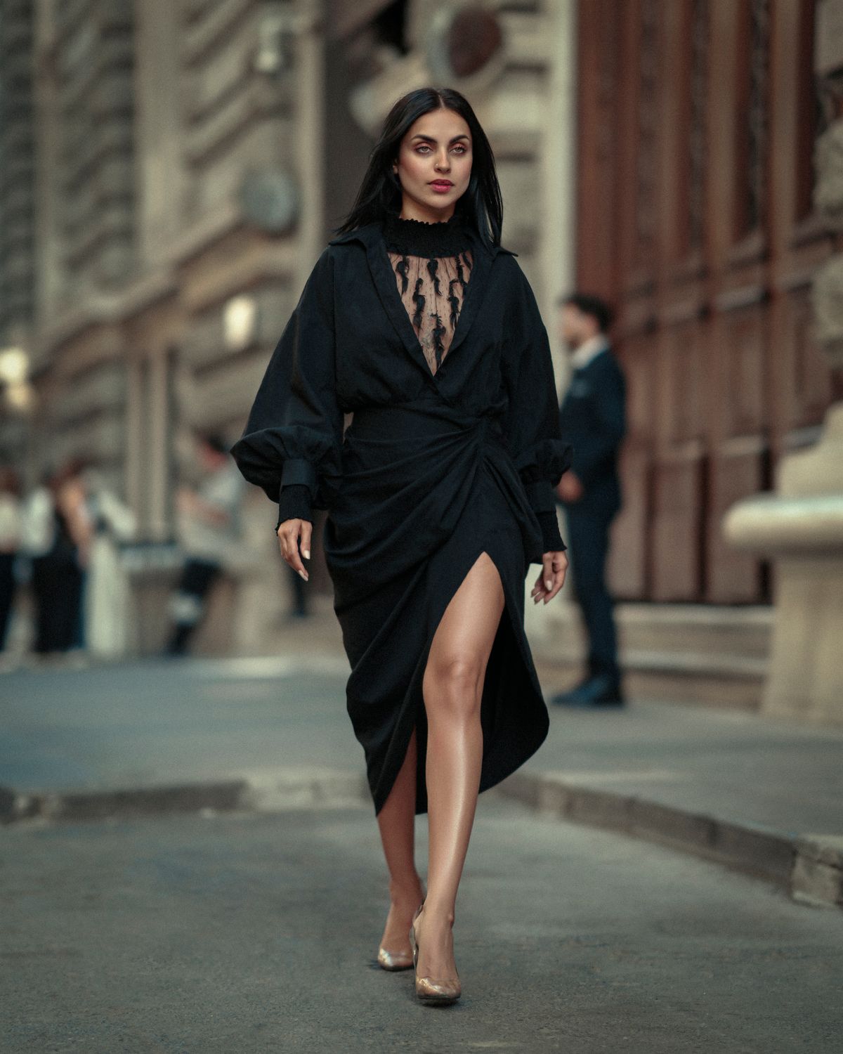 Woman walking in black wrap dress