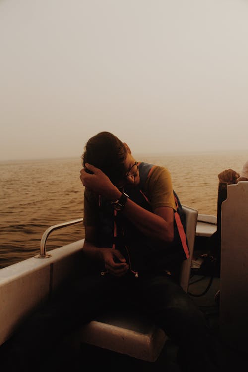 Man Sitting on A Boat