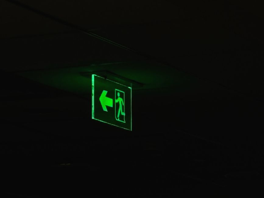 High-quality photoluminescent fire signs glowing in a darkened corridor - Fire fighting signs High-quality photoluminescent fire signs glowing in a darkened corridor - Fire fighting signs