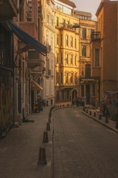 A serene city street with historic buildings bathed in warm golden hour sunlight.