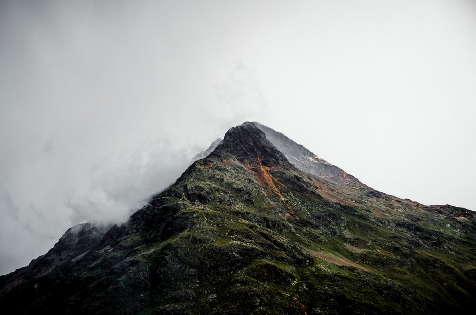 A stunning mist-covered mountain peak showcasing dramatic natural beauty and rugged terrain.