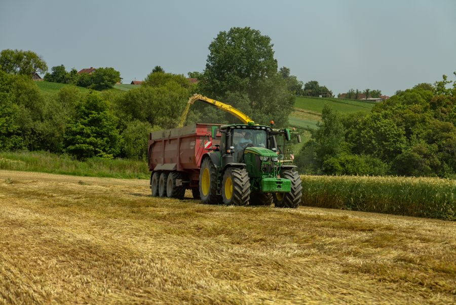 Tractor harvesting crops in a farm field