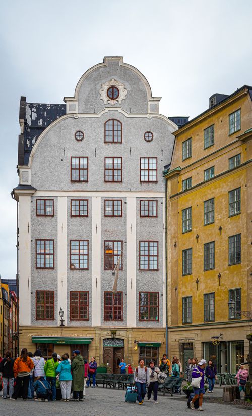 Free Charming historic buildings in Stockholm's Gamla Stan, Sweden with tourists admiring the architecture. Stock Photo