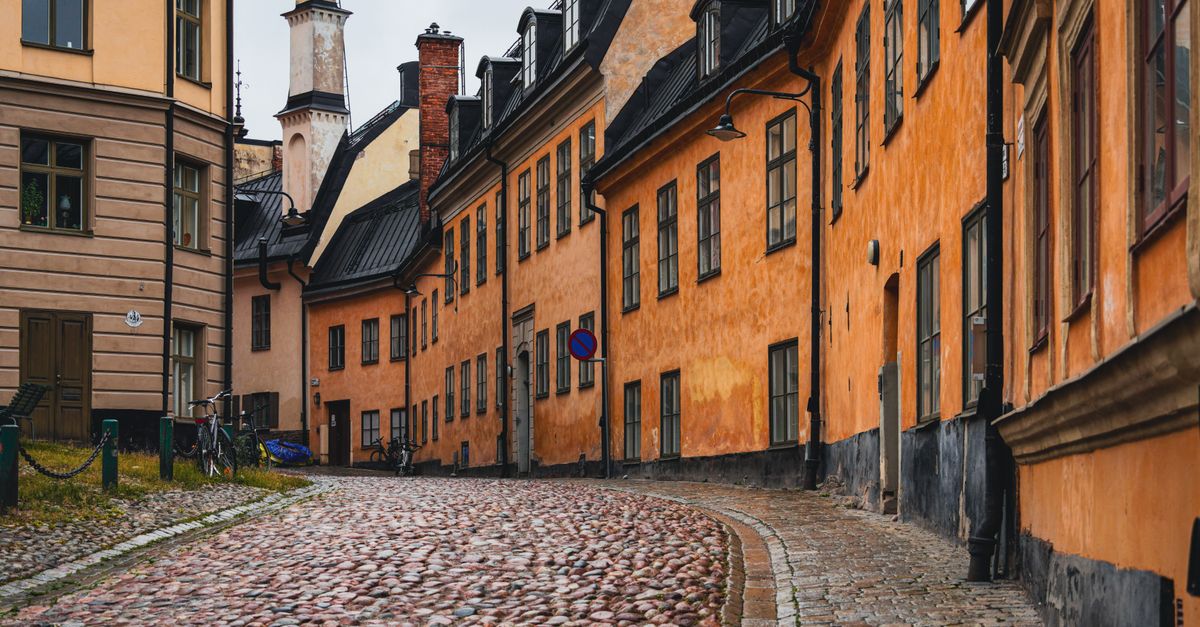 Beautiful narrow street lined with colorful historic buildings in Gamla Stan, Stockholm.