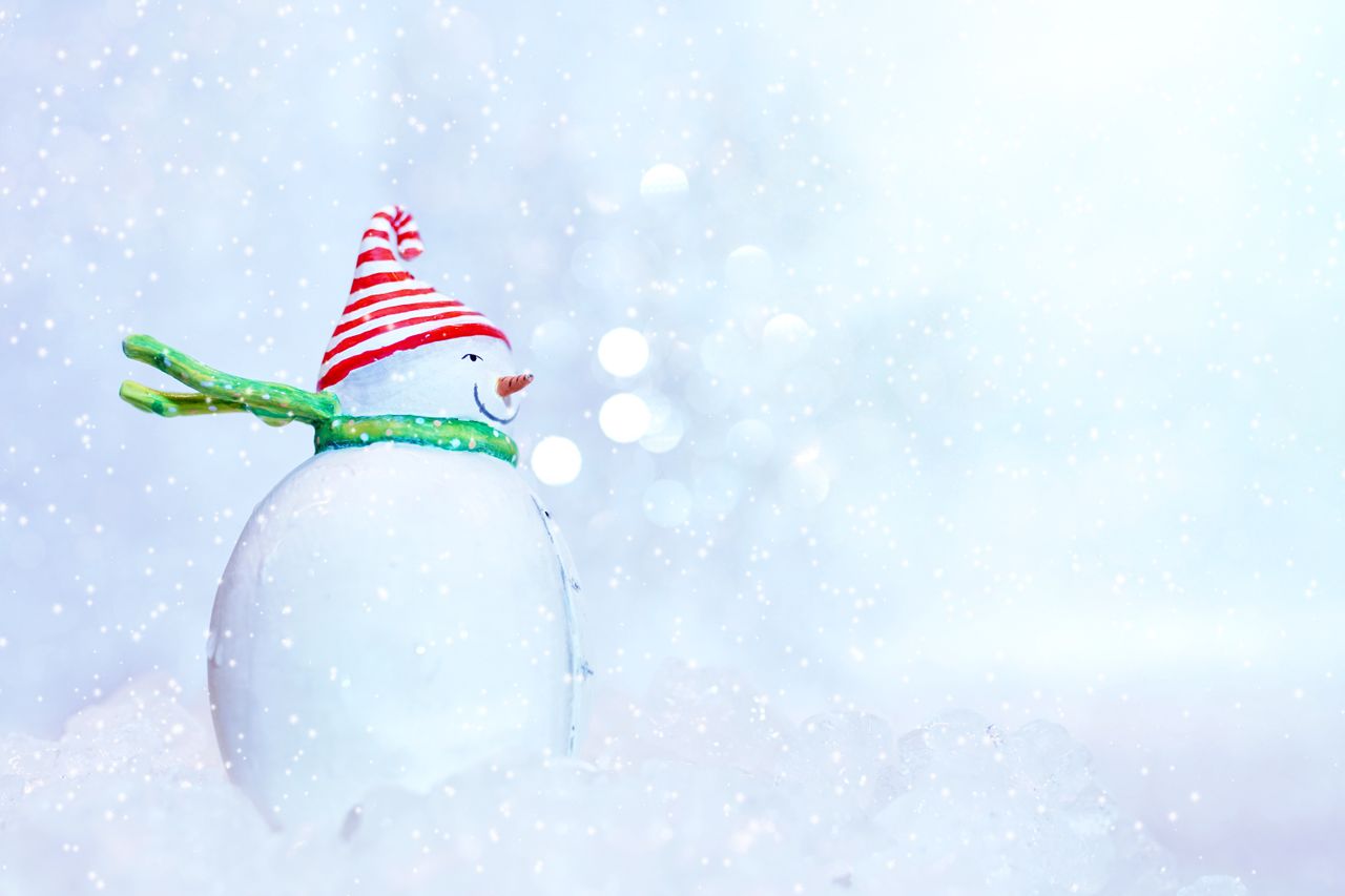 charming snowman with hat and scarf against a snowy frosty background