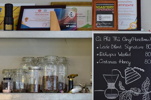 Chic coffee shop interior showcasing coffee beans, certificates, and a handbrew menu on a chalkboard.