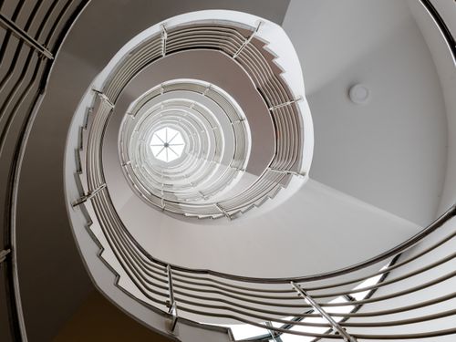 Free Intricate spiral staircase inside an office building in Hamburg, Germany showcasing modern architecture. Stock Photo